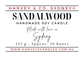 Product label for a Harvey & Co. Sydney Sandalwood Handmade Soy Candle, featuring red and black text on a white background.