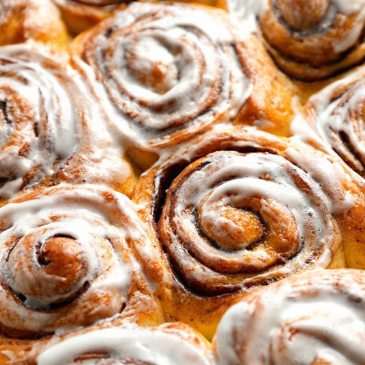 Close-up of glazed cinnamon scroll swirls with icing, Cinnamon Scrolls scented candle inspiration – Harvey & Co. Sydney®