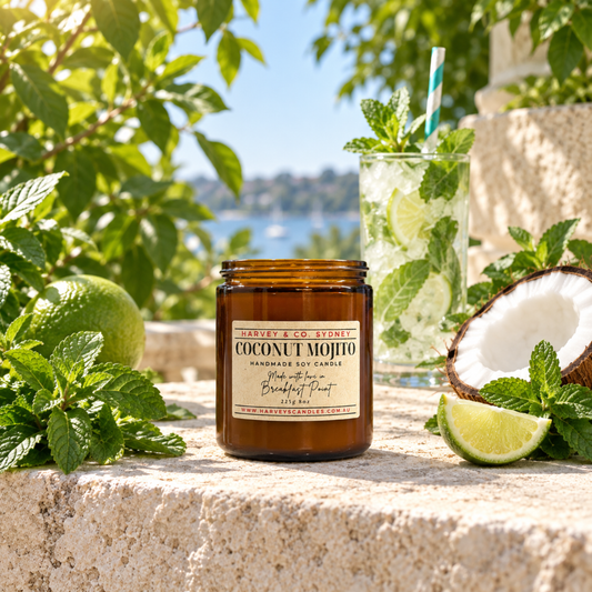  Harvey & Co. Sydney Coconut Mojito candle on pale stone, surrounded by fresh mint, lime, coconut and an iced mojito.