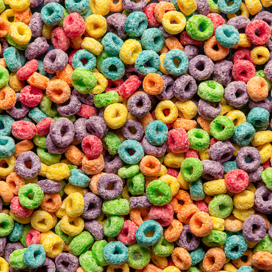 A close-up, top-down view of colorful loop cereal pieces filling the entire frame, with no packaging or background visible.