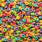 A close-up, top-down view of colorful loop cereal pieces filling the entire frame, with no packaging or background visible.