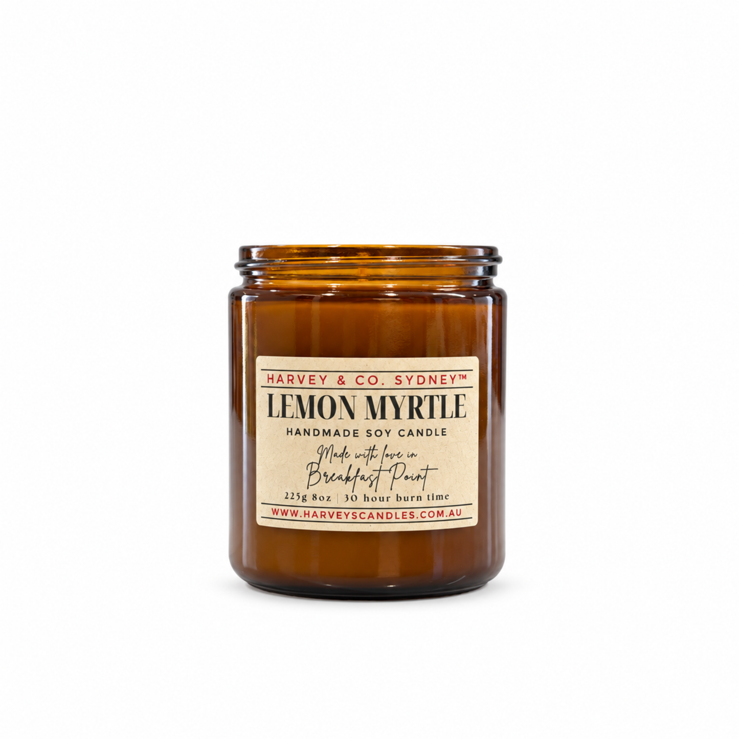 An amber glass jar candle with a cream label reading 'LEMON MYRLE' and 'Harvey & Co. Sydney', photographed on a clean white background.