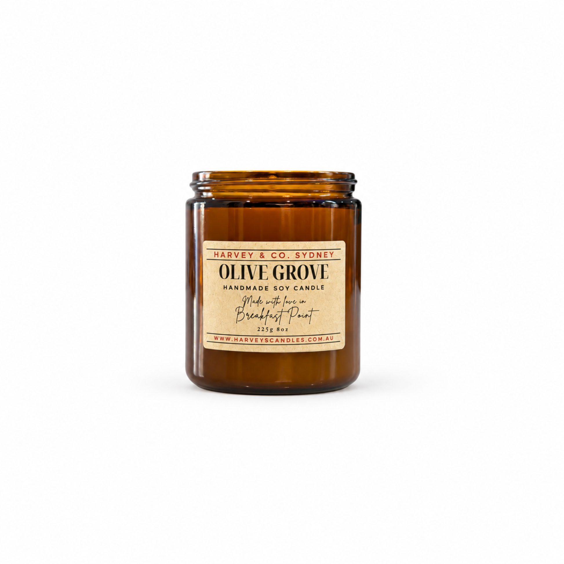 An amber glass jar candle with a cream-colored paper label reading 'OLIVE GROOVE' by Harvey & Co. Sydney, set against a plain white background.
