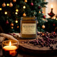 Jar of mulled wine candle with a Christmas tree in the background