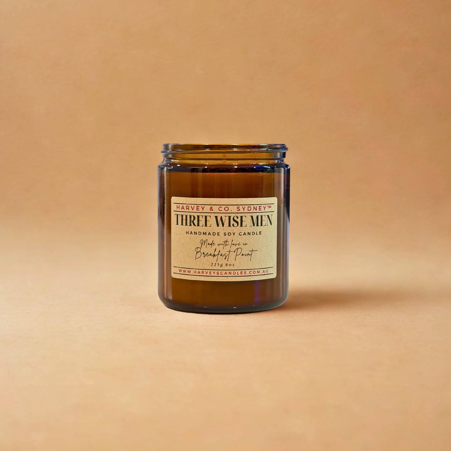 Candle jar labeled 'Three Wise Men' on a beige background