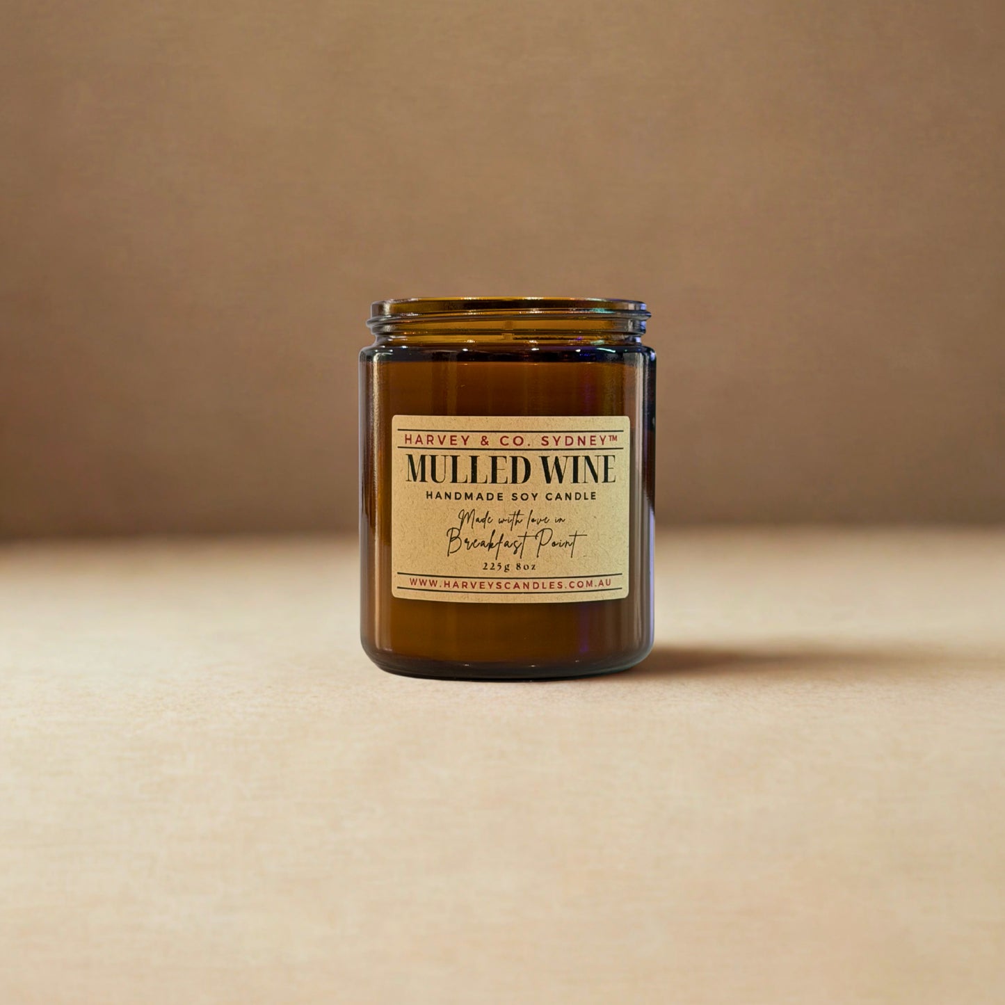 Jar of 'Mulled Wine' candle with a label on a beige background