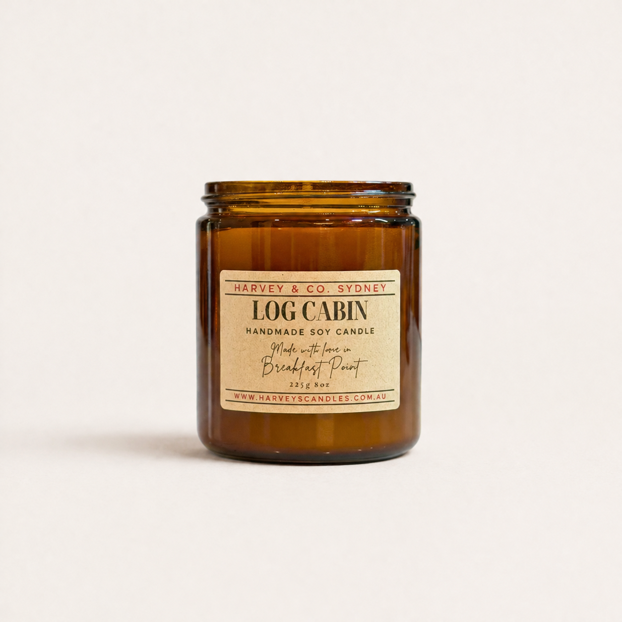 Amber candle jar with a label on a white background
