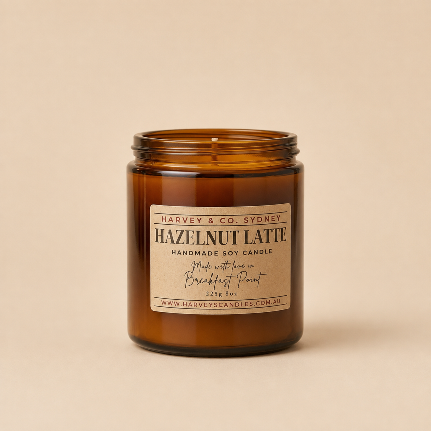 Coffee and hazelnut scented soy jar candle in amber glass with label showing Hazelnut Latte
