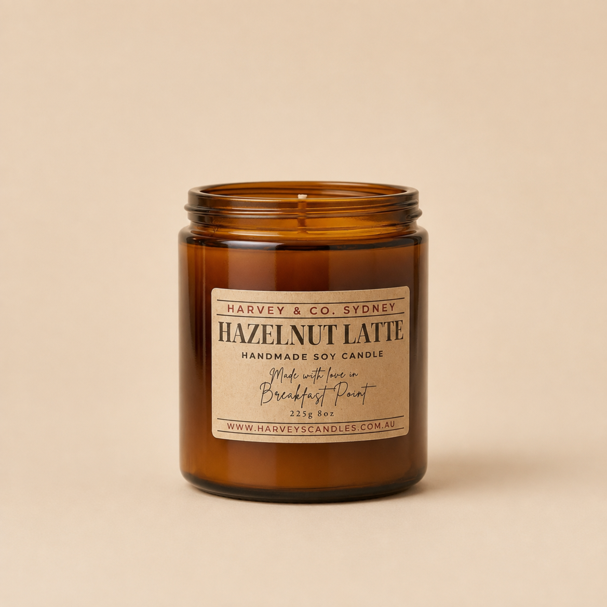 Coffee and hazelnut scented soy jar candle in amber glass with label showing Hazelnut Latte