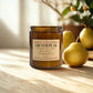 Candle labeled 'French Pear' by Harvey & Co. Sydney on a wooden surface with pears.