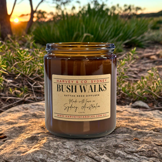 Jar of 'Bush Walks' candle by Harvey & Co. Sydney on a rock with a sunset background