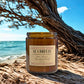 Harvey & Co. Sydney sea breeze candle on a beach with ocean and sky in the background