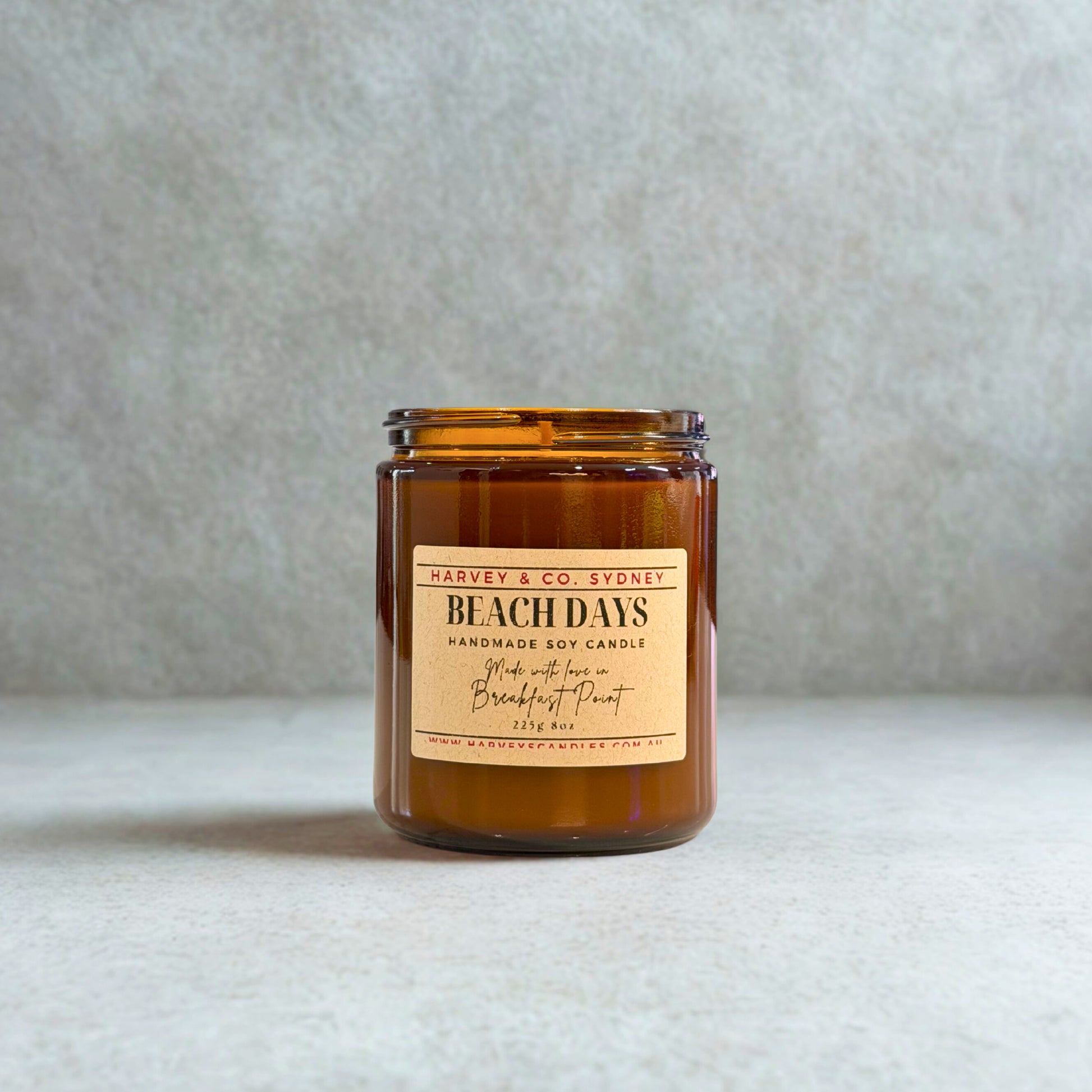 Brown candle jar with a label on a light gray background