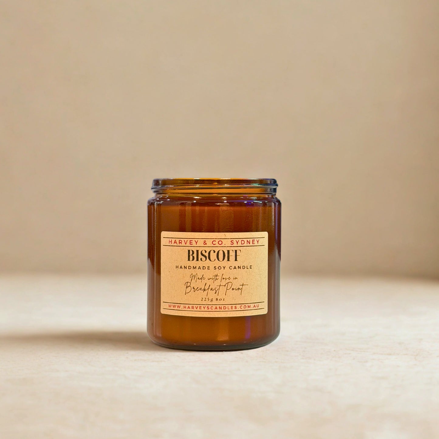 Brown candle with a label on a beige background