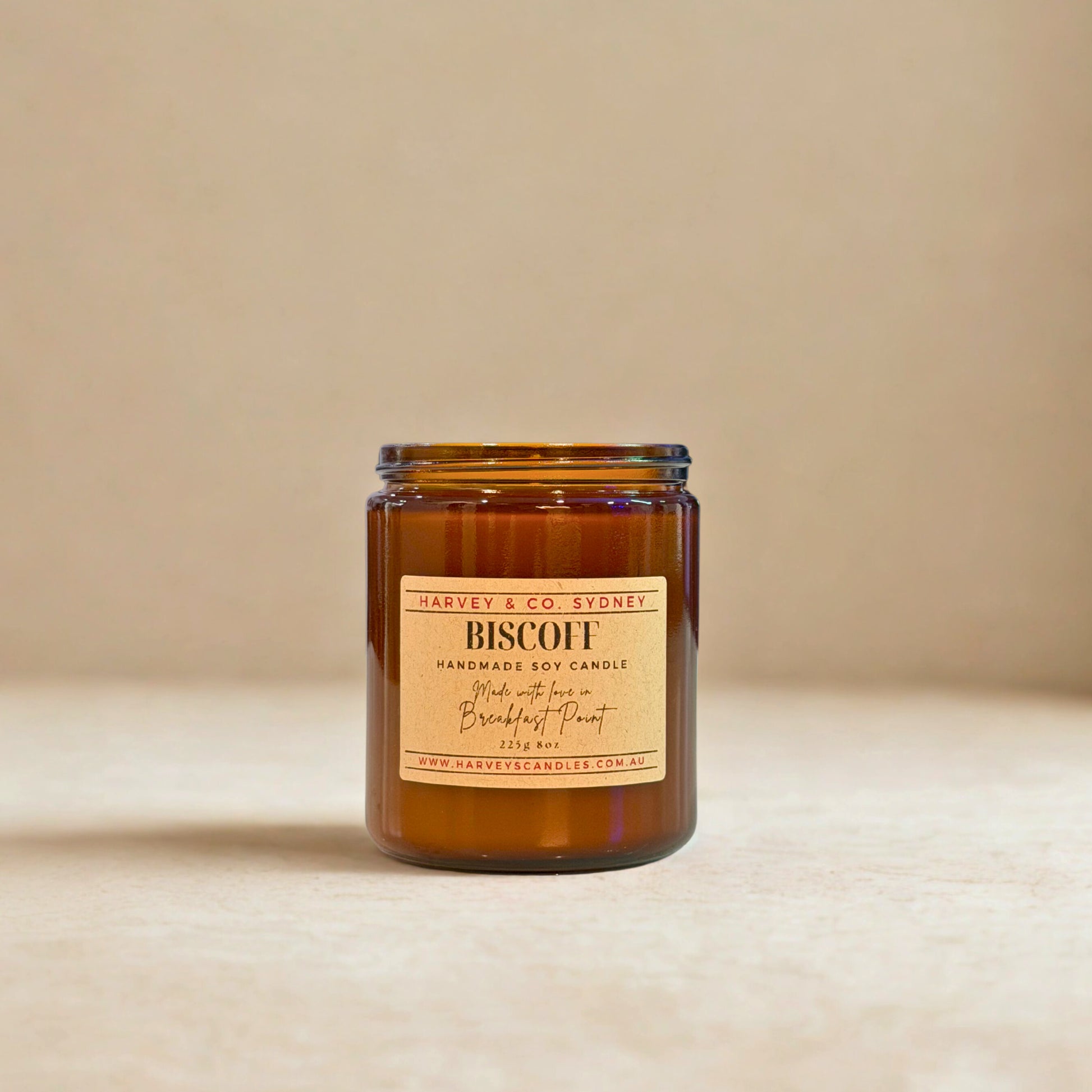Brown candle with a label on a beige background