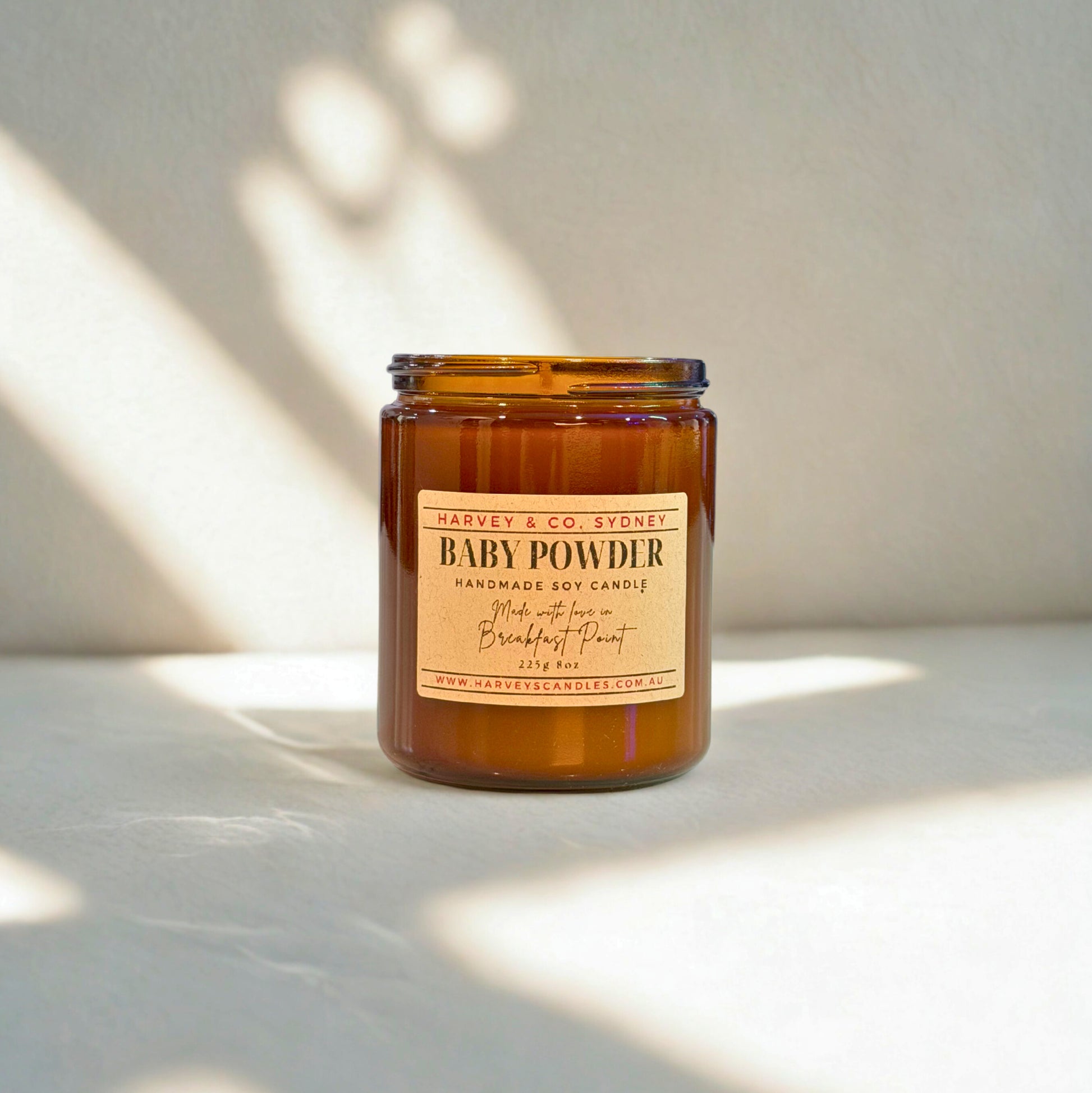 Candle jar labeled 'Baby Powder' by Harvey & Co. Sydney on a light background
