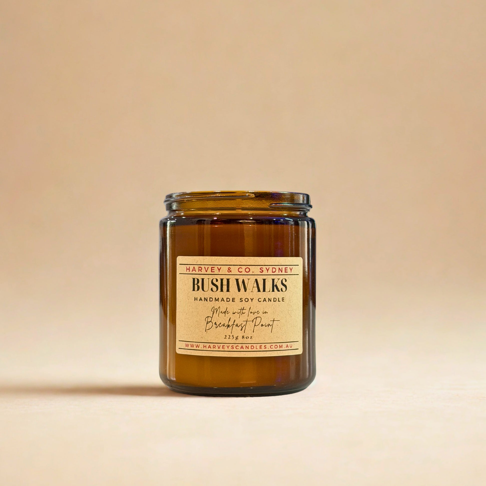 Brown candle jar with a label on a beige background
