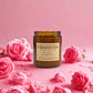Candle labeled 'Turkish Delight' surrounded by pink roses on a pink background