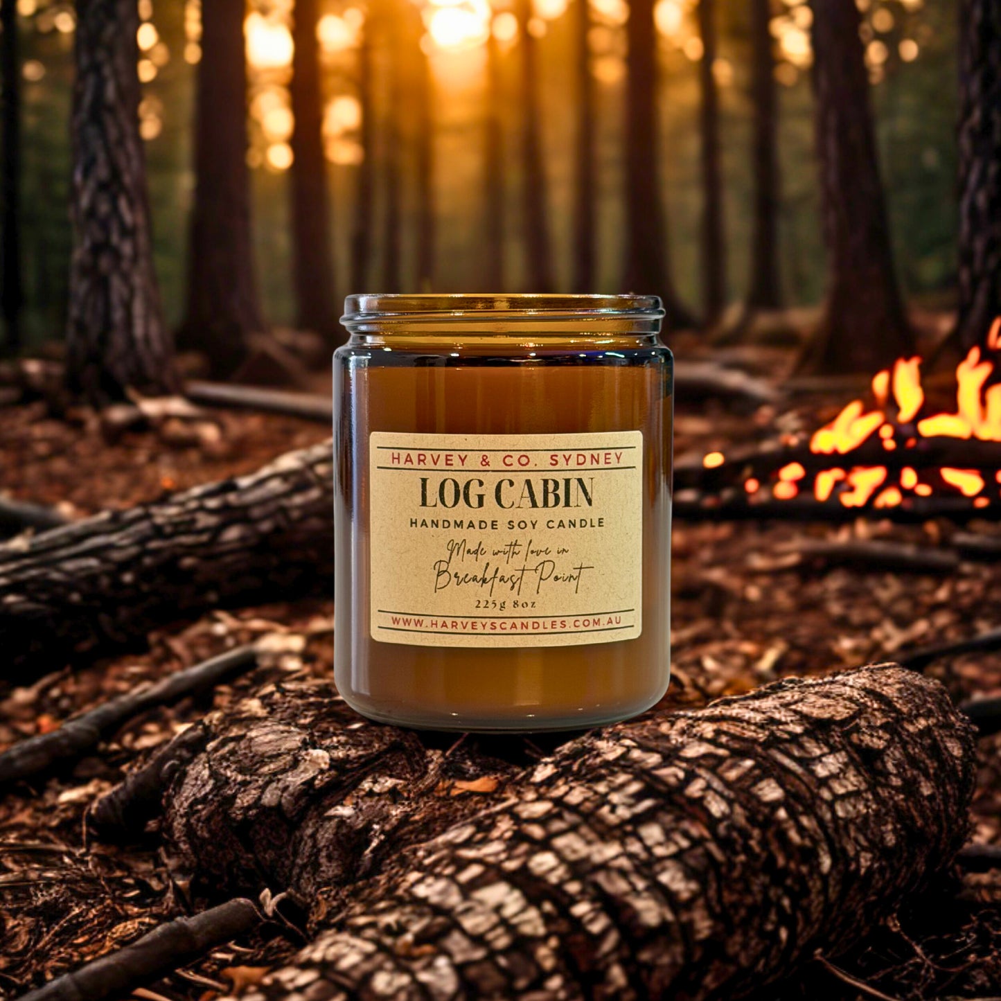 Harvey & Co. Sydney Log Cabin candle on a log with a forest background