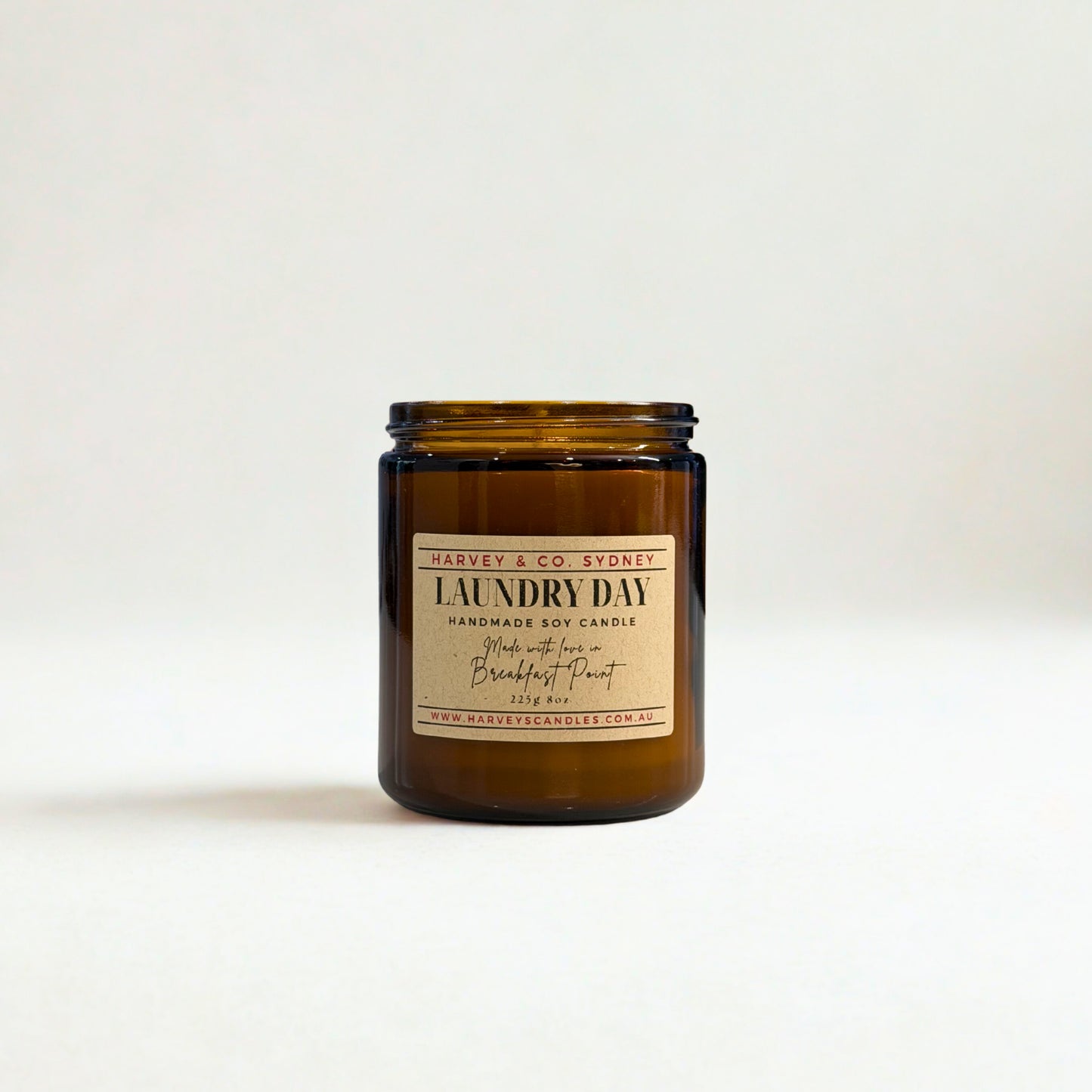 Brown candle jar labeled 'Laundry Day' on a white background