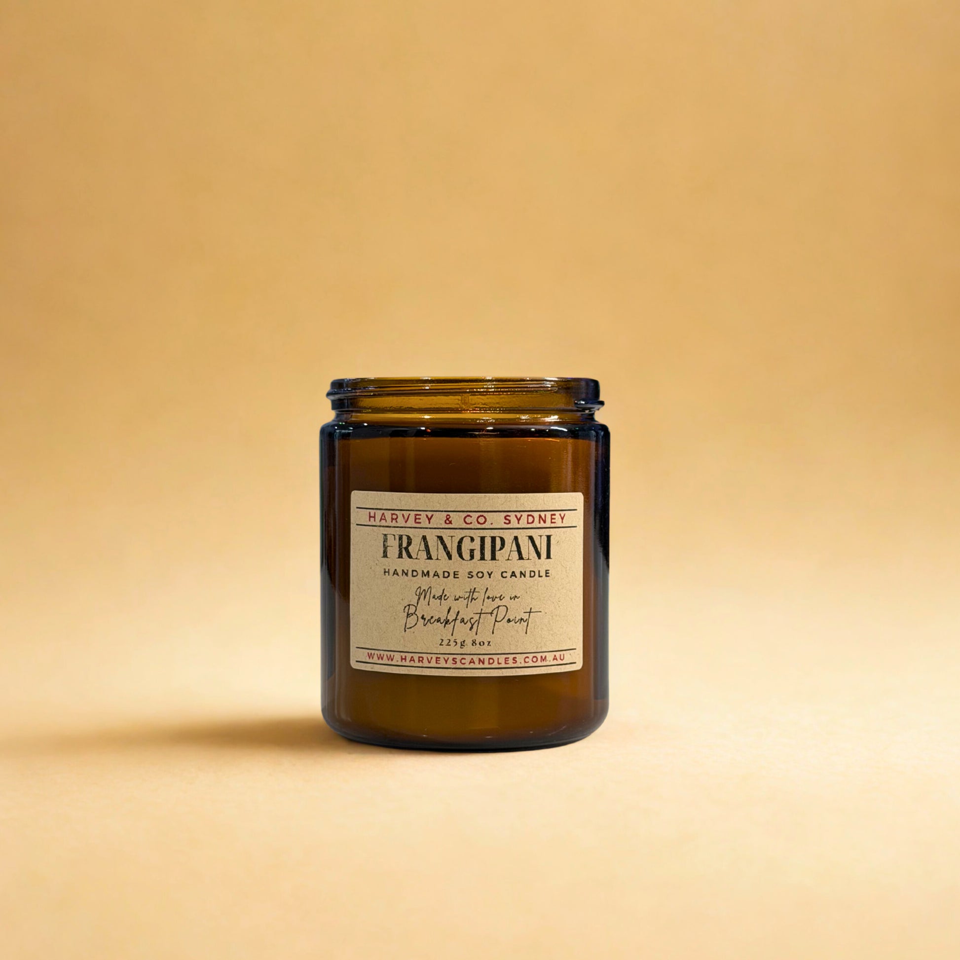 Brown candle jar with a label on a beige background