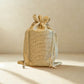 Jute drawstring bag on a beige background