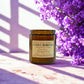 Candle labeled 'Native Boronia' by Harvey & Co. Sydney with purple flowers in the background.