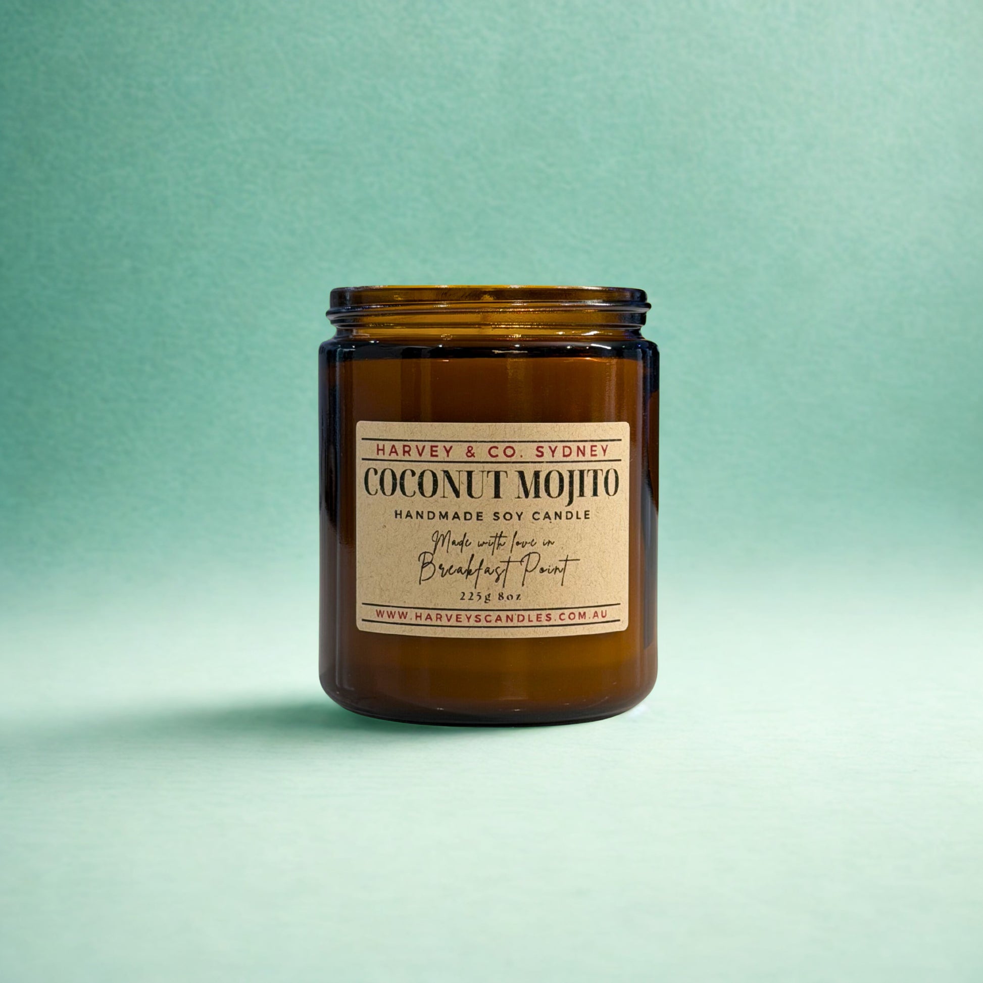 Brown candle jar with a label on a light green background