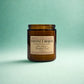 Brown candle jar with a label on a light green background