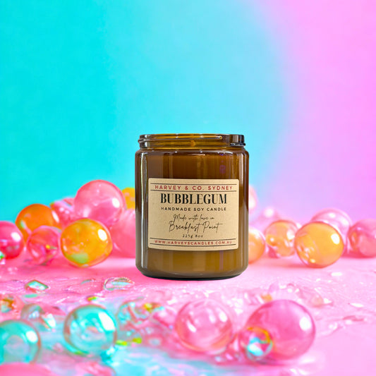Brown candle jar labeled 'Bubblegum' with colorful bubbles on a gradient background