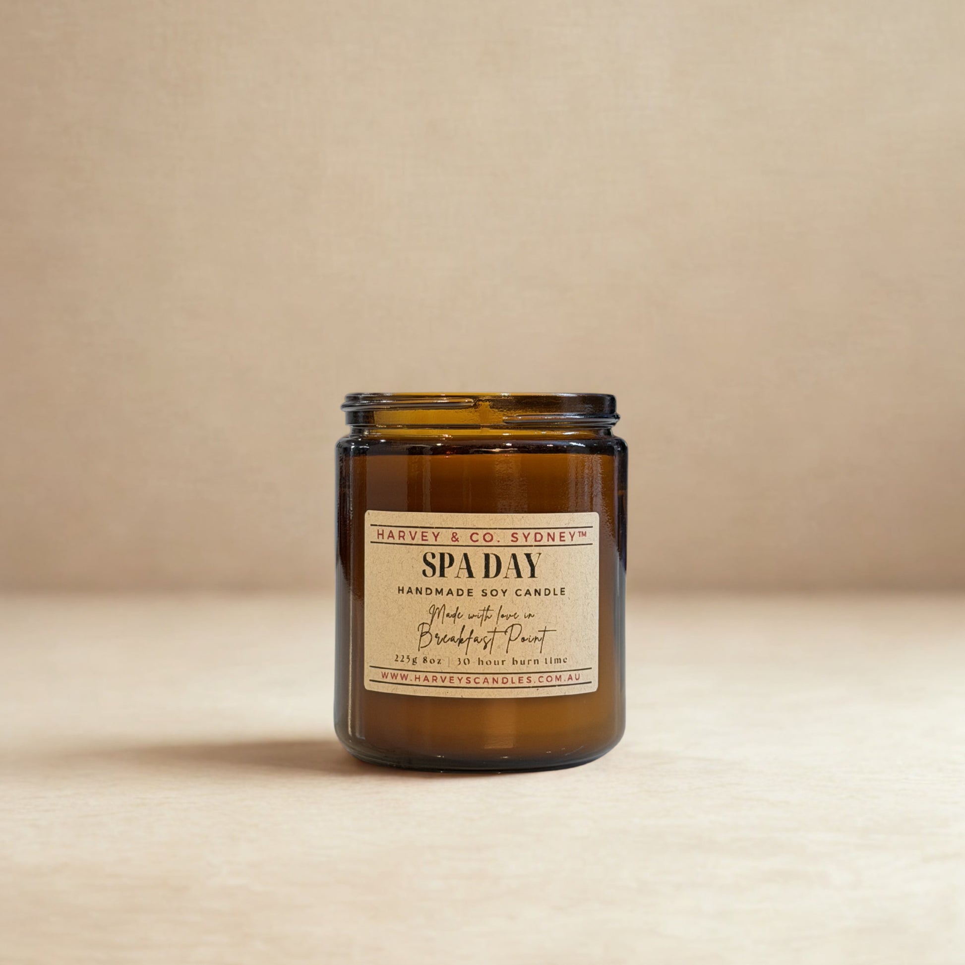 Brown glass candle labeled 'SPA DAY' on a beige background