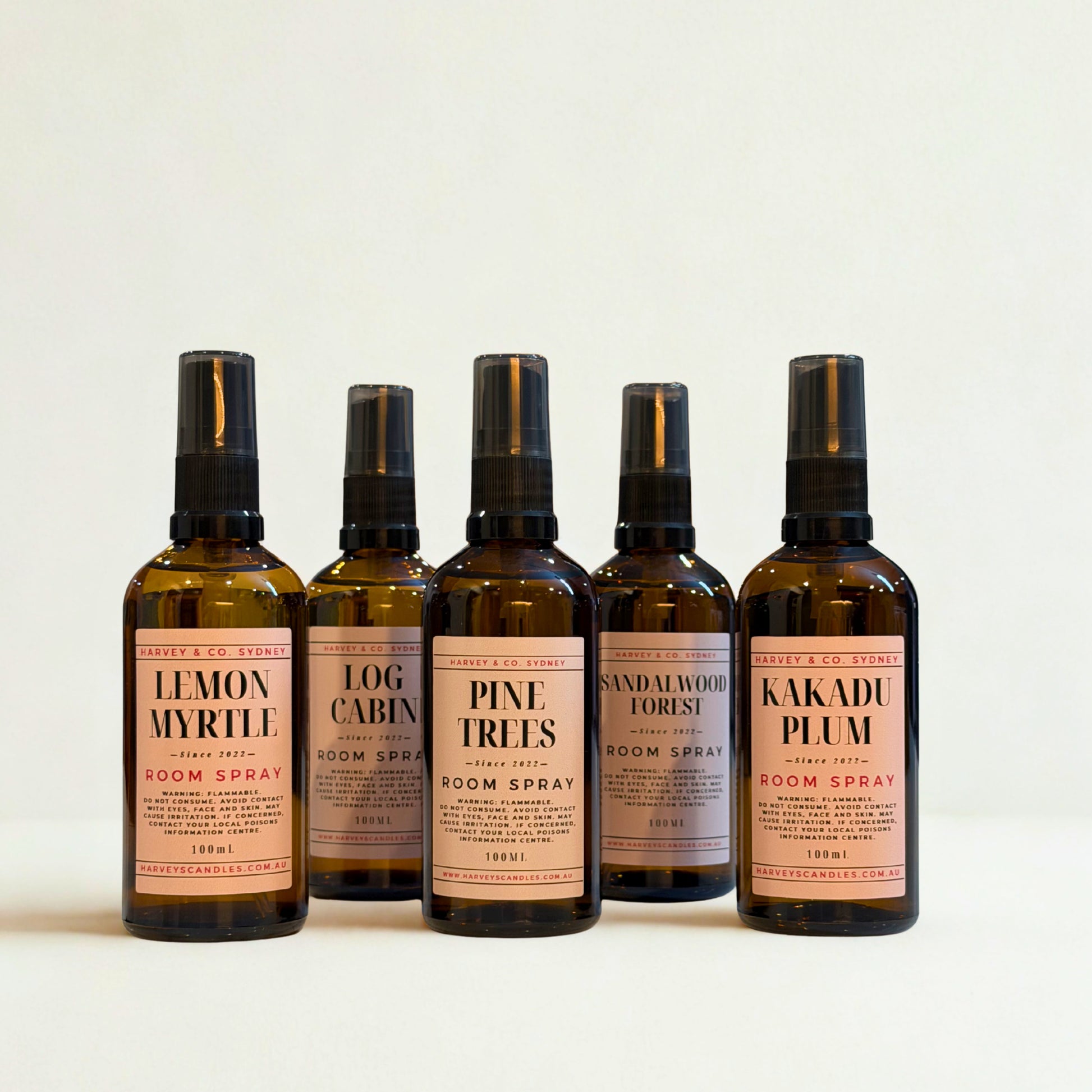 Five bottles of room spray with labels on a white background