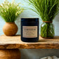 Harvey & Co Sydney lemongrass candle on a wooden surface with plants in the background