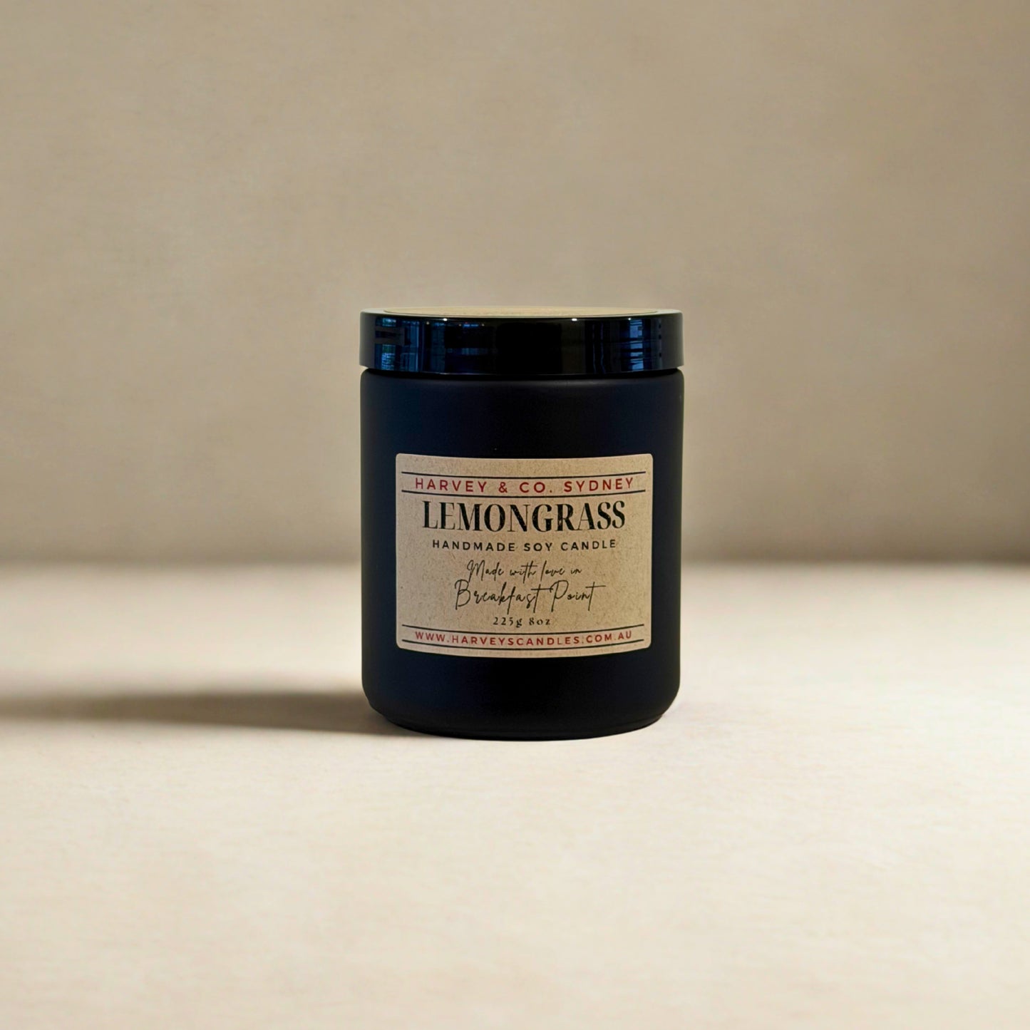 Black candle jar with 'Harvey & Co Sydney' label on a beige background