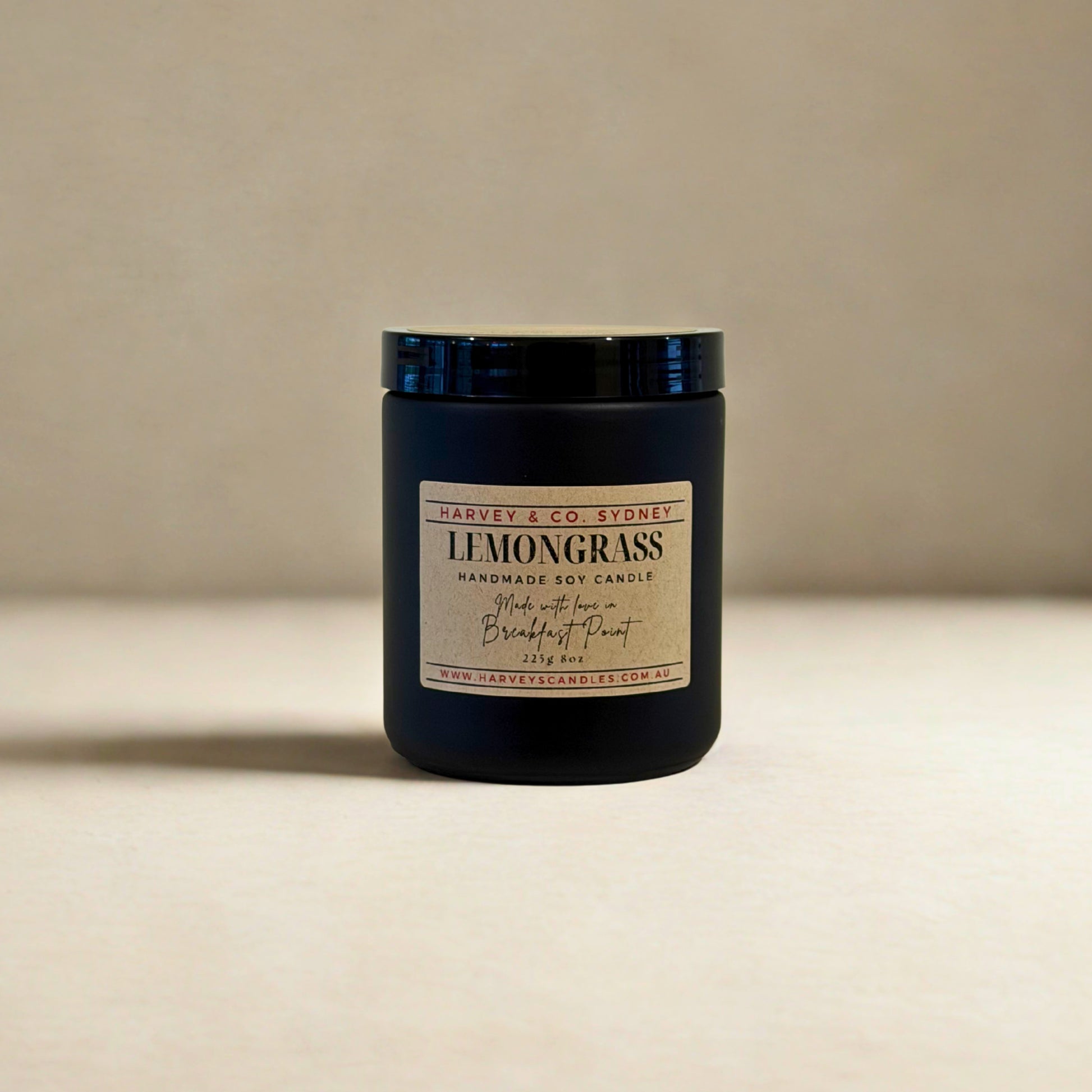 Black candle jar with 'Harvey & Co Sydney' label on a beige background