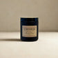 Black candle jar with 'Harvey & Co Sydney' label on a beige background