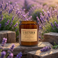 Harvey & Co. Sydney lavender candle on a wooden surface with lavender flowers in the background