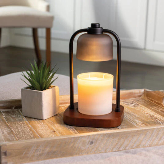 Decorative lantern with candle on a wooden table in a home setting