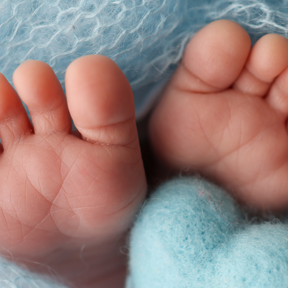 Close-up of a baby's feet wrapped in blue fabric